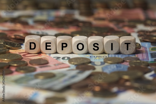 deposit - cube with letters, money sector terms - sign with wooden cubes photo