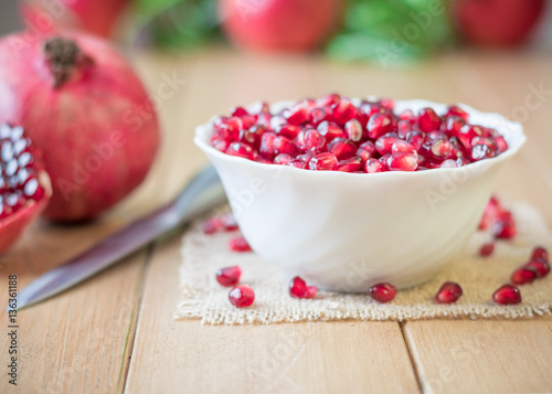 Still life with fresh pomegranate on a wooden table.