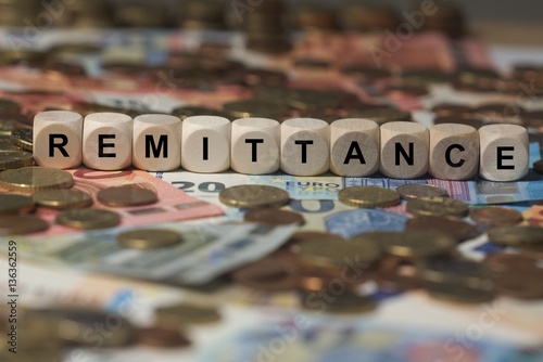 remittance - cube with letters, money sector terms - sign with wooden cubes