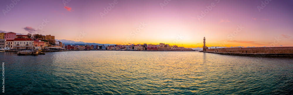 Panorama of the beautiful old harbor of Chania with the amazing lighthouse, at sunset, Crete, Greece.