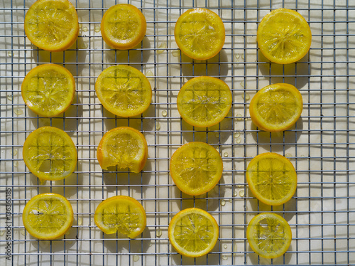 Just candied slices of oranges drying on a pastry rack.