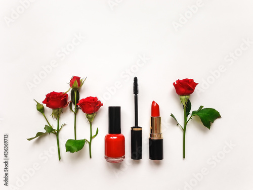 Decorative flat lay composition with cosmetics and flowers. Flat lay, top view