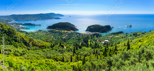 Beautiful summer panoramic seascape. View of the coastline into the sea bays with crystal clear azure water. In the backlight sunbeam light. Paleokastrica. Corfu. Ionian archipelago. Greece.