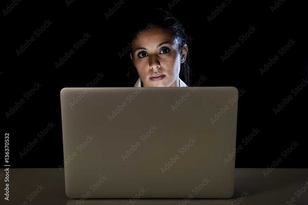 young business woman or student girl working in darkness on laptop computer late at night tired