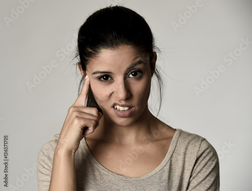 beautiful arrogant and moody spanish woman showing negative feeling and contempt facial expression