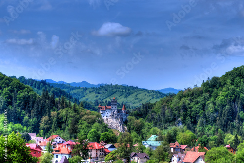 Famous Dracula castle surrounded by medieval architecture in Bran town, Romania