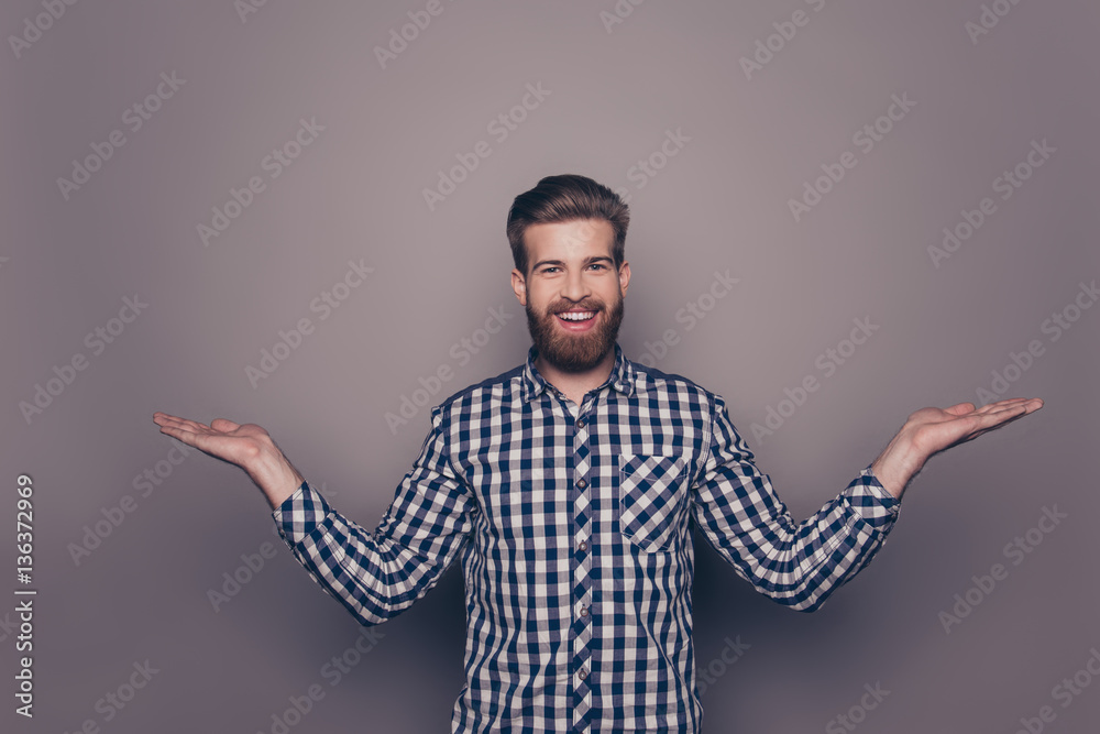 Young happy bearded man gesturing with hands and showing balance