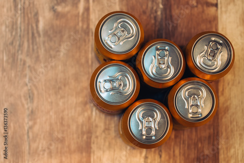 Beer cans on rustic wooden table top view