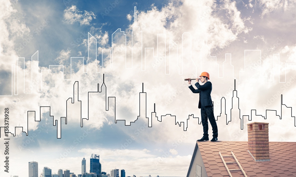 Engineer man standing on roof and looking in spyglass. Mixed med Engineer man standing on roof and looking in spyglass. Mixed med