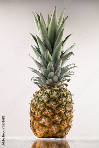 Ripe and juicy pine aaple on a white background photo