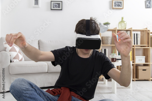 Boy with VR glasses in living room
