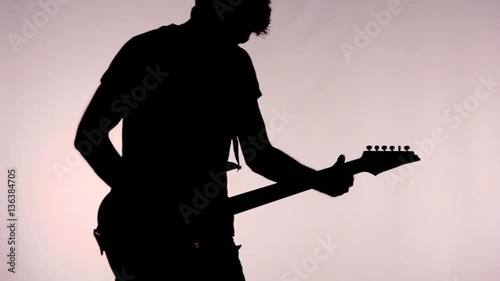 Silhouette of man playing guitar