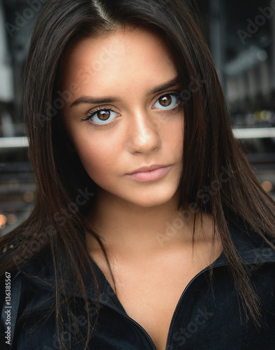 Close-up portrait of a beautiful young brunette girl with big eyes in  casual comfortable clothes. Daily simple makeup. Huge eyes. Good vision.  Lens. Photos