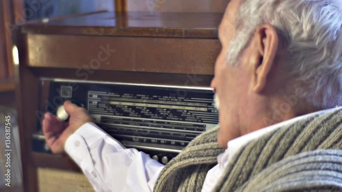 Senior Man is Setting Vintage Radiogram Listening to Music of His Youth Grandfather is Resting Outdoors and Talking Nostalgia Sweet Memories and Dreams