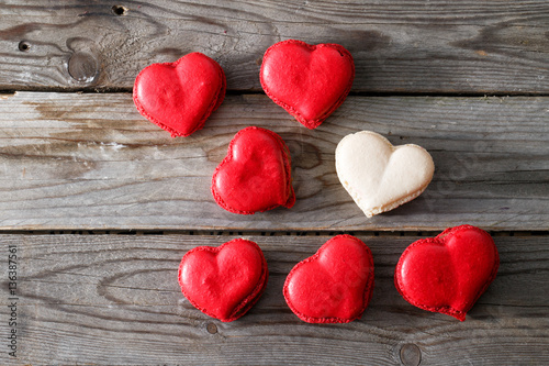 Fototapeta Naklejka Na Ścianę i Meble -  Red macaroons desserts on wooden background. dessert for breakfast on Valentine's Day