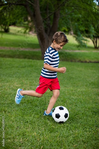 Boy playing football in park © WavebreakMediaMicro