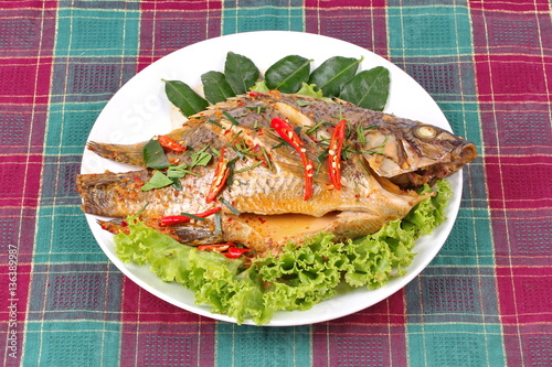 Curry-fried Tilapia fish with spicy topping.