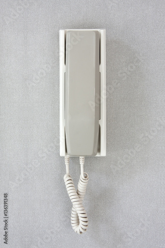 Wall phone on gray background.