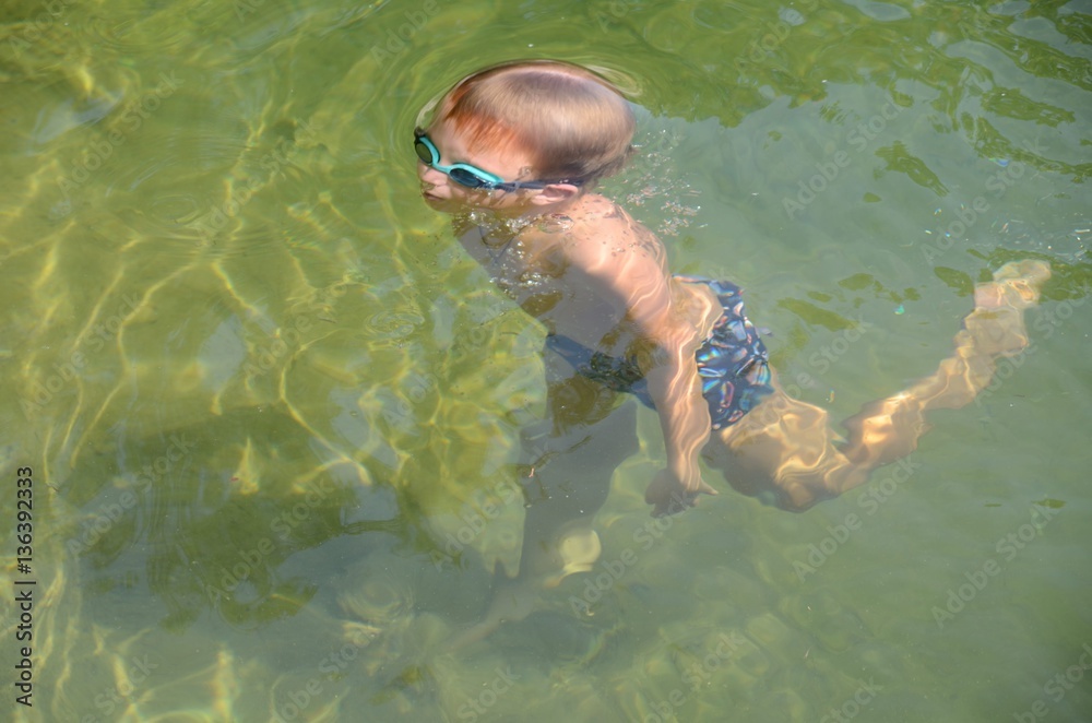 boy diving in pond