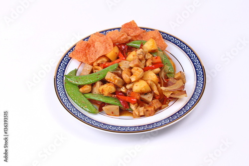 Fried mixed fruit and vegetable with roasted chili plate .