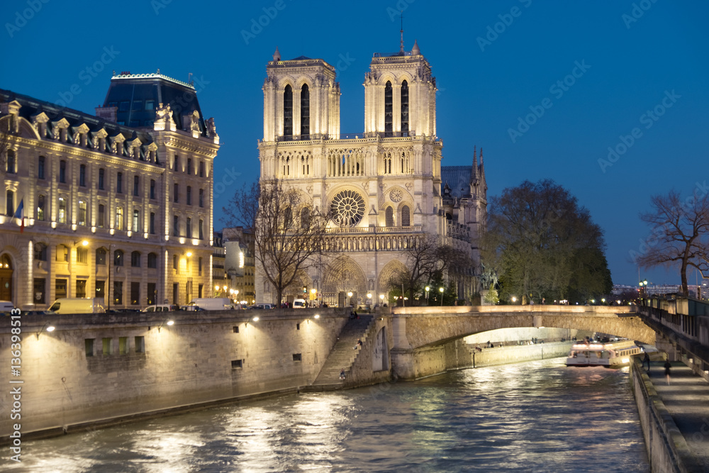 Illuminated Seine river and Notre-Dame cathedral at night