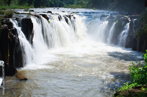 waterfall in Laos with red water