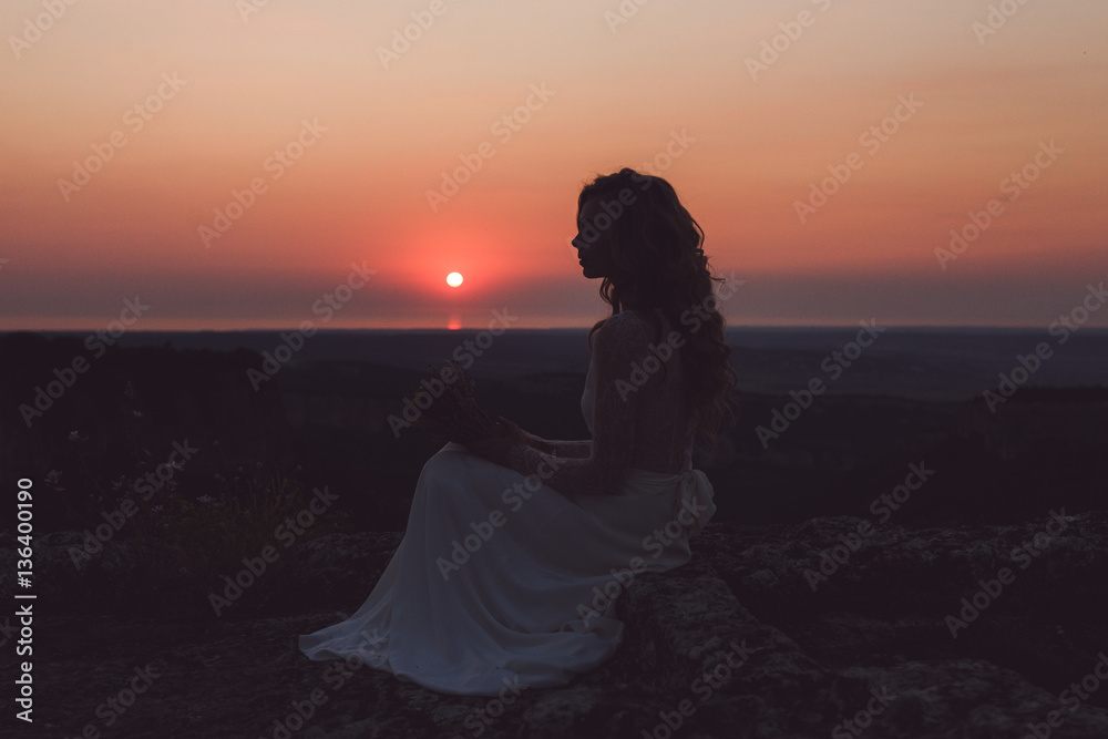 Silhouette of woman at colorful red sunset
