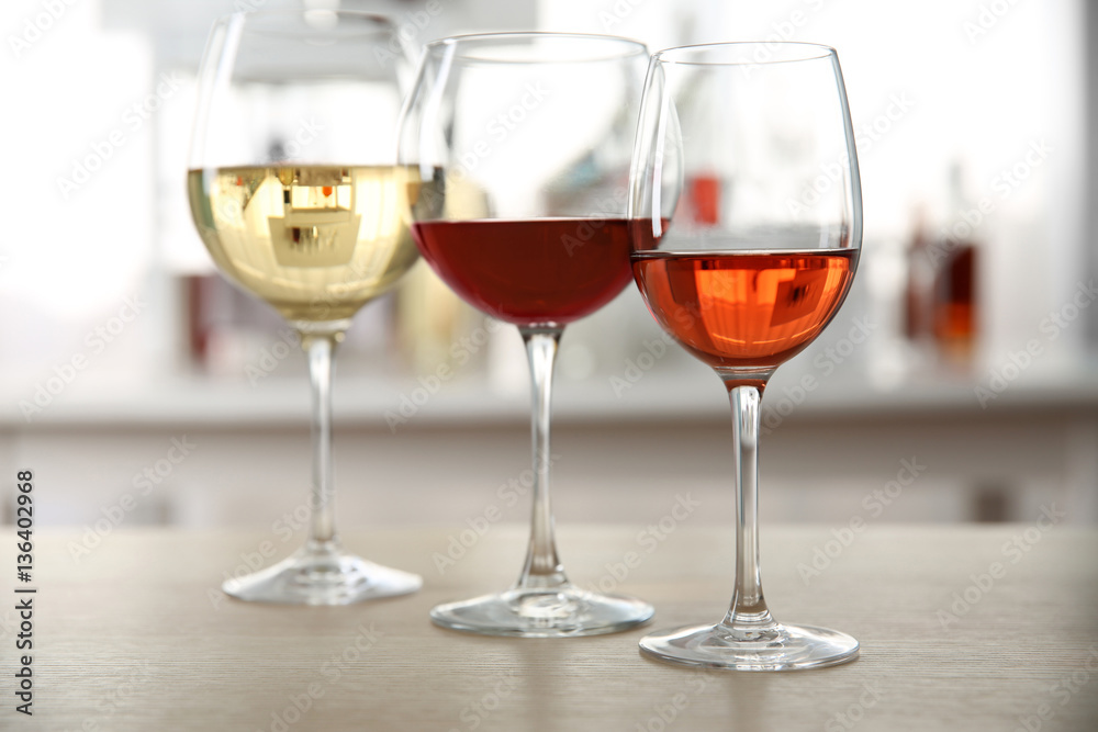 Three glasses with wine on kitchen table