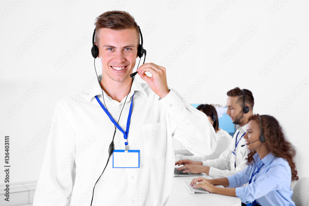 Young male technical support dispatcher working in office, closeup Young male technical support dispatcher working in office, closeup