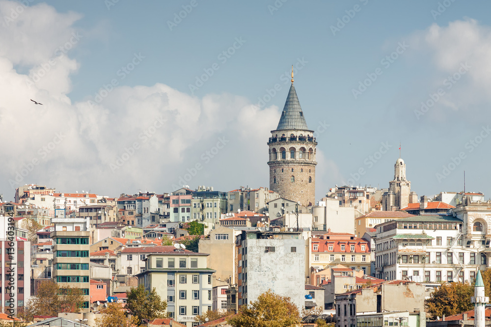 Sunny view of Bosphorus with excursion boats and Galata Tower, Istanbul, Turkey.