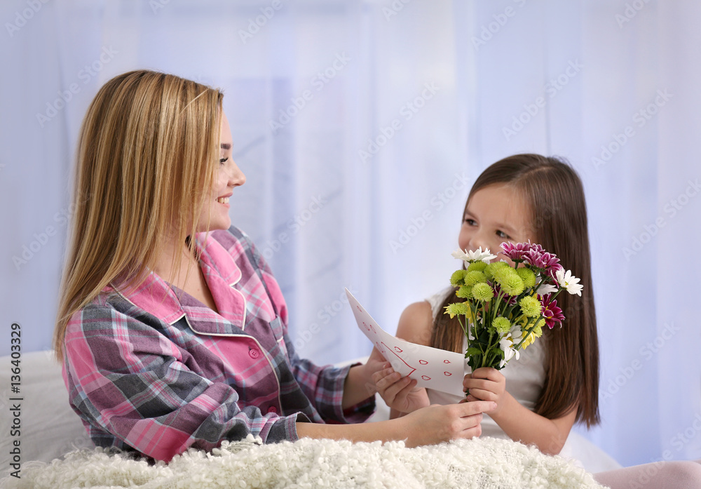 Cute little girl greeting her mother at home. Mother's day concept Cute little girl greeting her mother at home. Mother's day concept