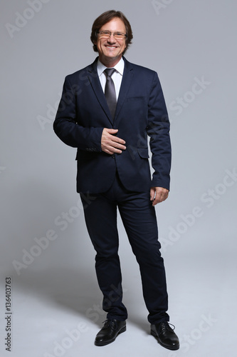 Confident man in suit on gr...