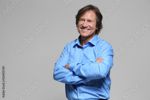 Confident mature man on gre...