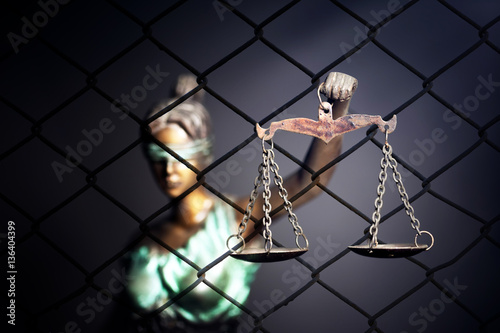 Lady Justice against cage background