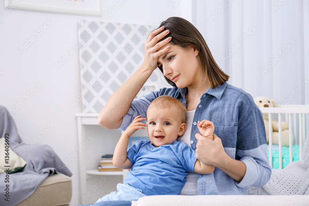 Depressed young woman with cute baby at home Depressed young woman with cute baby at home