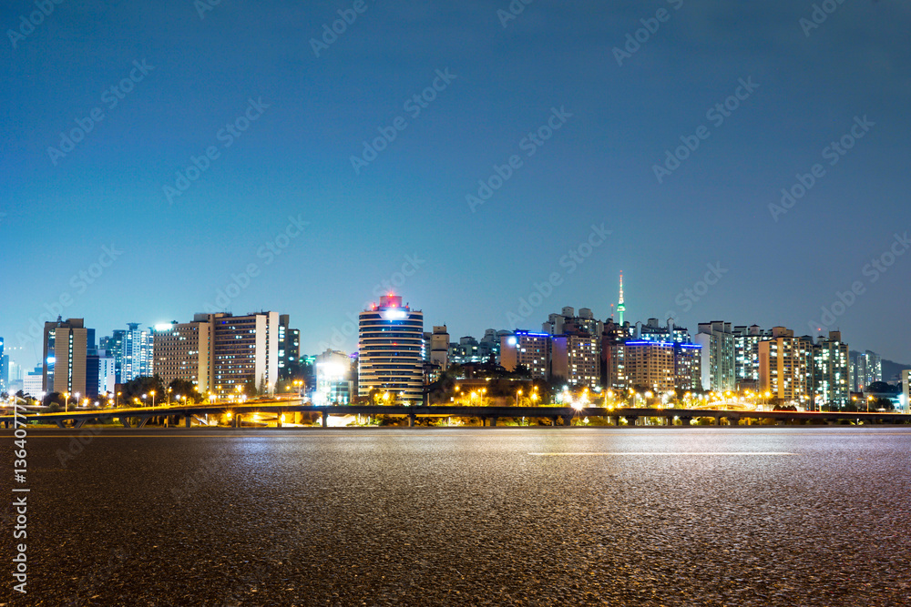 cityscape and skyline of seoul at night from empty road
