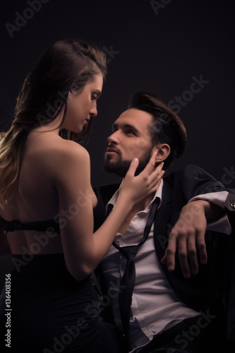 yonng couple sexy passion woman pulling necktie