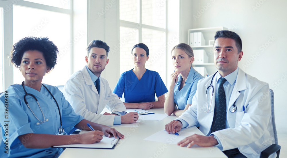 group of happy doctors meeting at hospital office group of happy doctors meeting at hospital office
