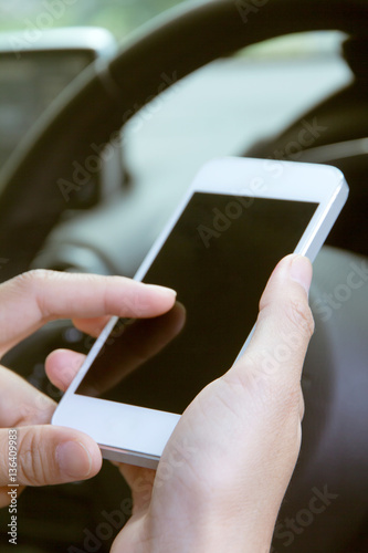 image of using a mobile phone inside of a car. communication networking