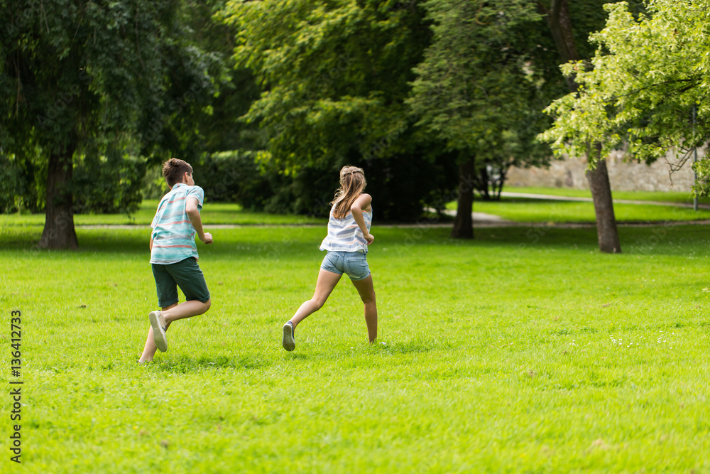 group of happy kids or friends playing outdoors