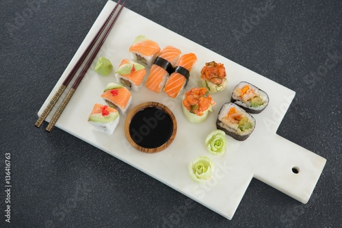Various sushi on tray with sauce