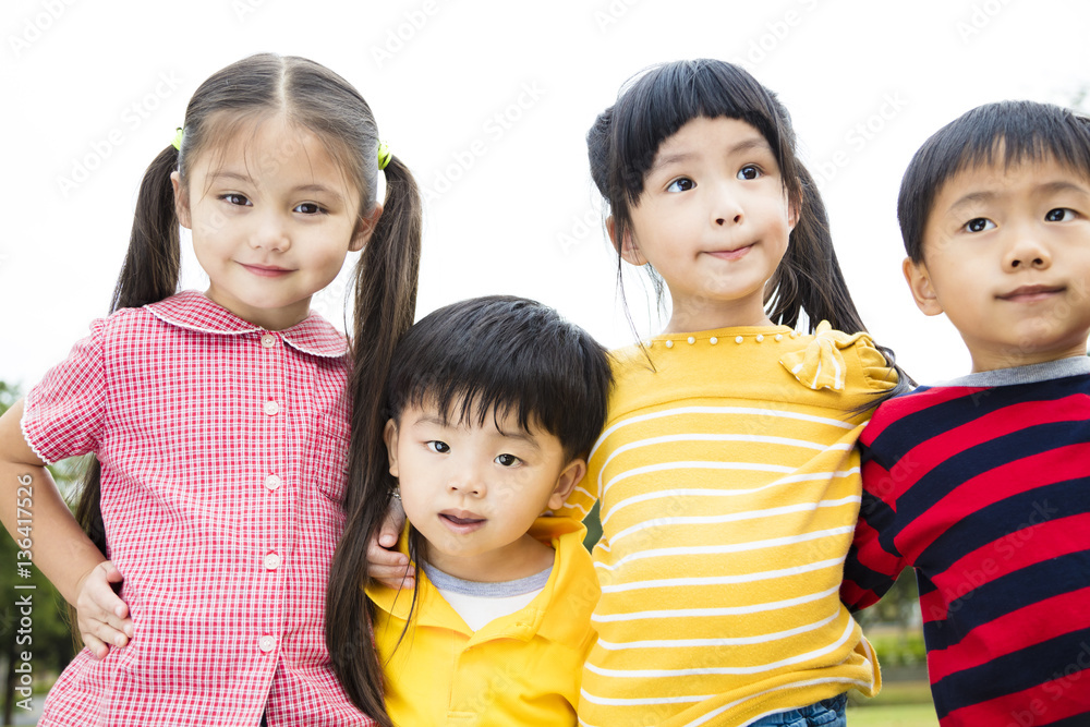 Group of smiling kids standing outside together Group of smiling kids standing outside together