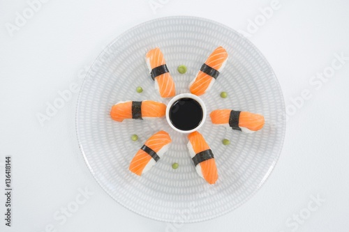 Sushi served on plate with sauce
