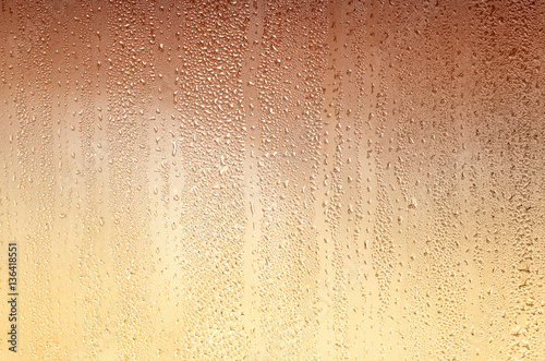 Background with drops on glass, stained yellow-brown. Plenty of space for text.