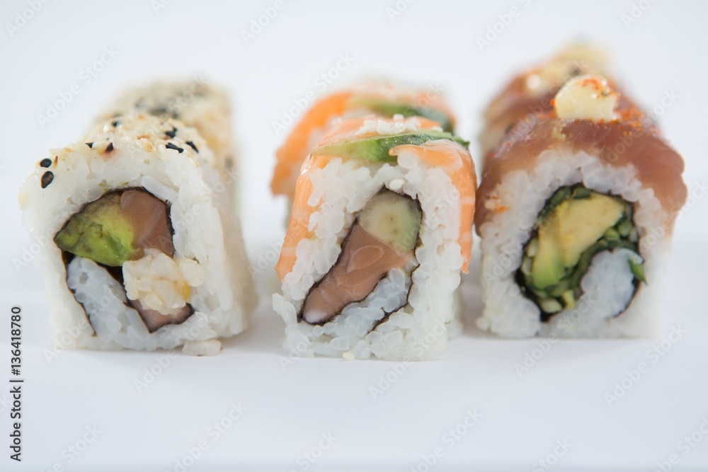 Uramaki sushi roll on white background Uramaki sushi roll on white background