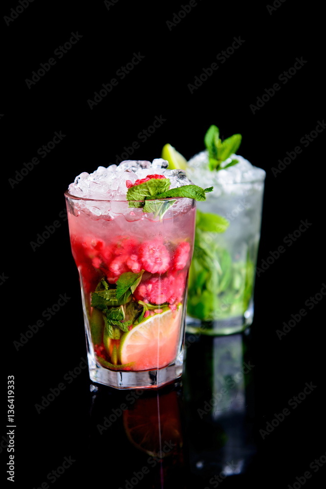 cold drink with mint and raspberries on black background cold drink with mint and raspberries on black background