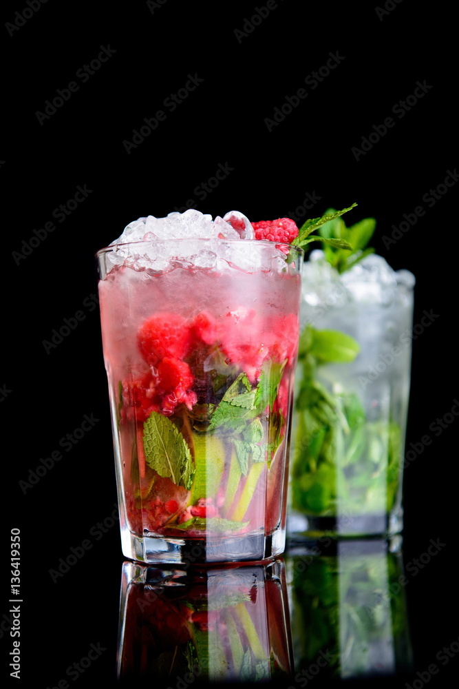cold drink with mint and raspberries on black background cold drink with mint and raspberries on black background