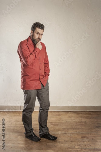 Pensive, confident adult European man with beard