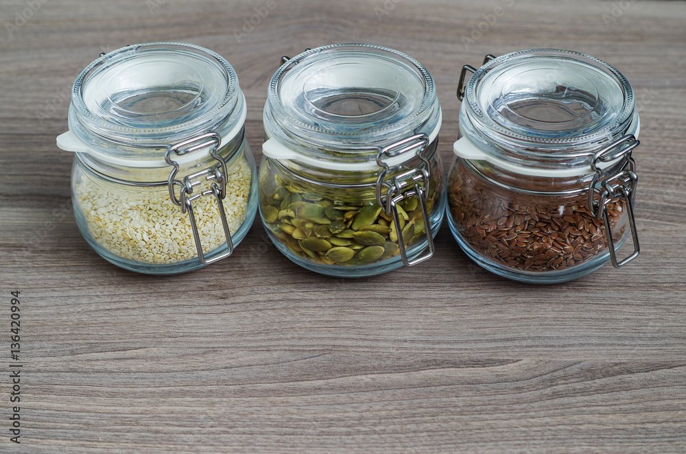 Collection of sesame seeds, flax seeds, pumpkin seeds in glass jar Collection of sesame seeds, flax seeds, pumpkin seeds in glass jar