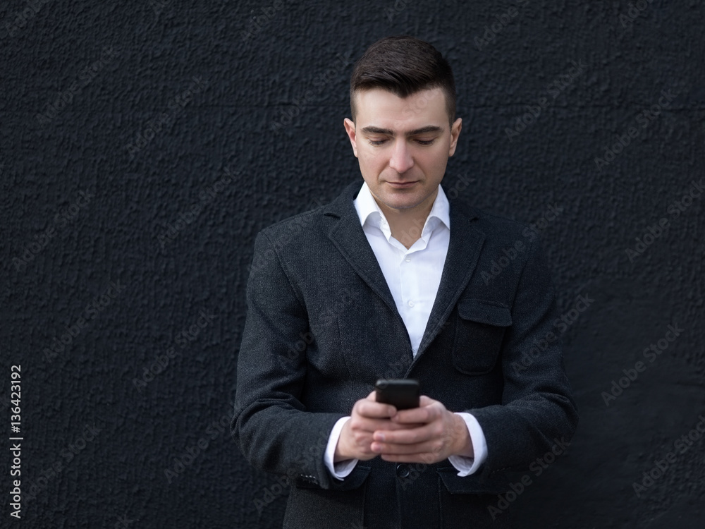 Young business man outdoors using smartphone Young business man outdoors using smartphone